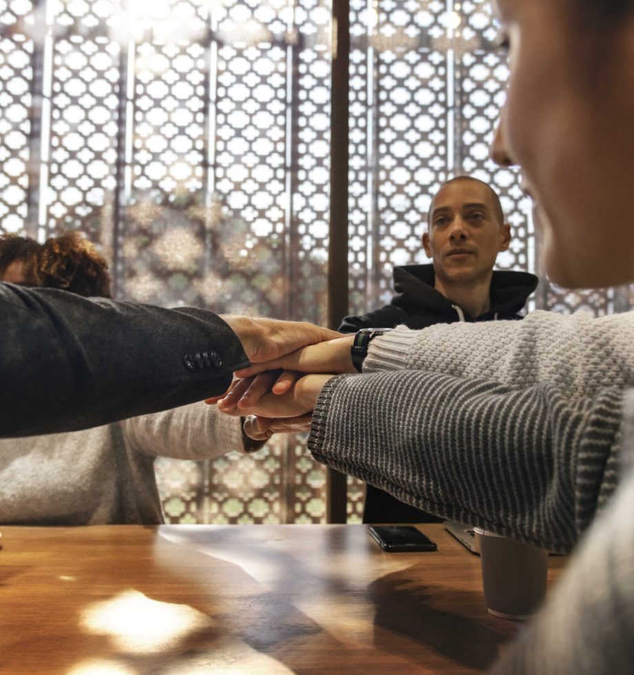 Diverse people stacking hands together
